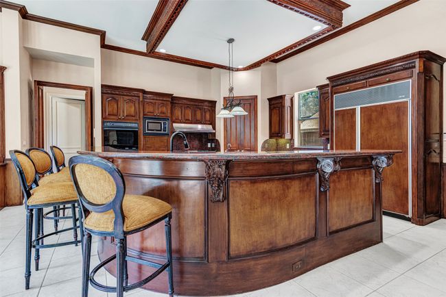 The kitchen has the same rich woodwork with exquisite details you'll find throughout the house. Even around the Sub-Zero fridge! | Image 14