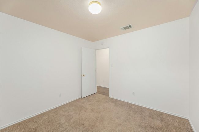Unfurnished room with baseboards, visible vents, and light colored carpet | Image 13