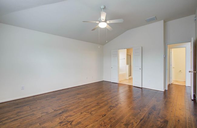 Primary bedroom has en suite bath and views to the back yard. | Image 21