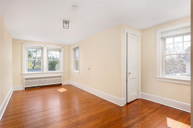 Unfurnished room featuring radiator, baseboards, and wood finished floors | Image 10