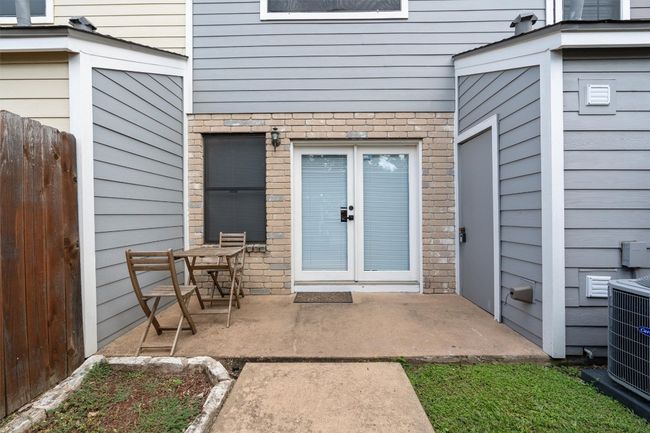 Doorway to property featuring brick siding and a patio | Image 5