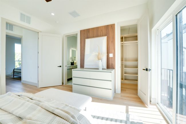 Bedroom with a spacious closet, light wood-type flooring, and a closet | Image 22