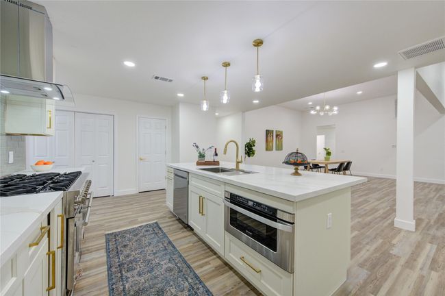A 6-burner Professional Series Gas Range is the star of the kitchen, perfect for the home chef. The custom cabinetry offers plenty of storage, while new lighting fixtures brighten the entire space. | Image 14