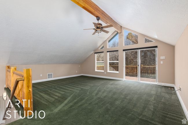 Additional living space featuring lofted ceiling with beams, dark colored carpet, a ceiling fan, and baseboards | Image 36