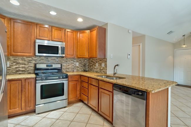 You'll love the layout of this kitchen with multiple storage solutions, and helpful updates including a recently installed garbage disposal. | Image 11