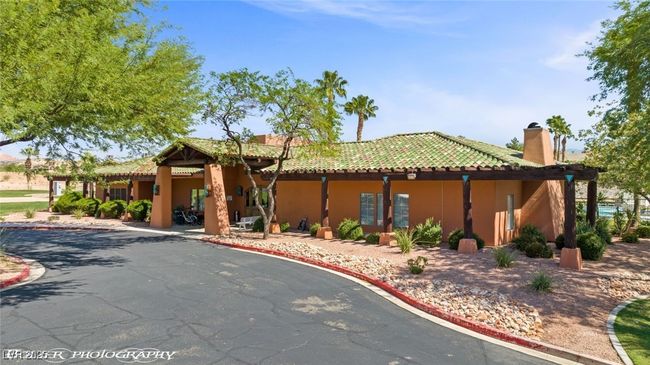 View of front facade with a chimney, stucco siding, and a tiled roof | Image 65