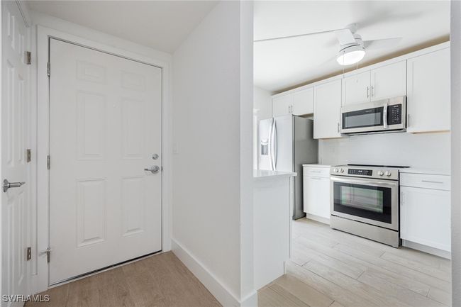 Front Door entryway with half-bath | Image 5