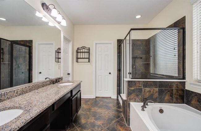Master Bathroom with walk in shower, bench and garden tub. | Image 22