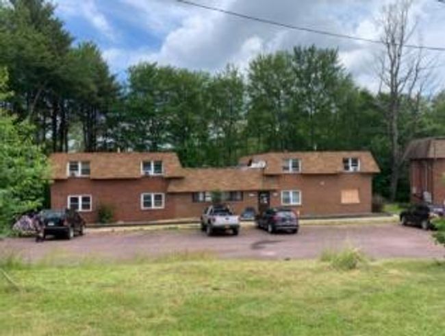 Back of house with uncovered parking and a lawn | Image 30