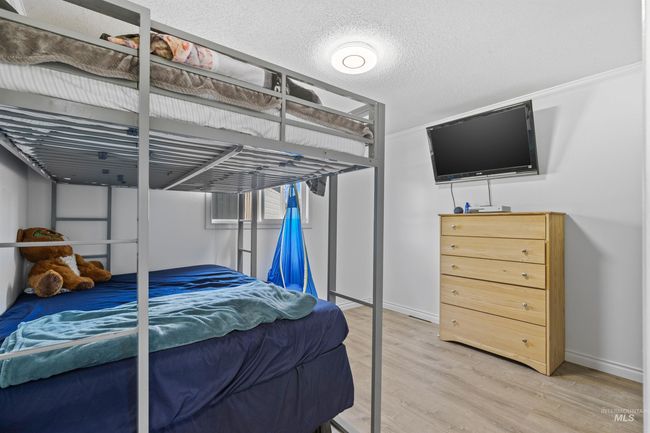 Bedroom featuring light wood finished floors and baseboards | Image 18