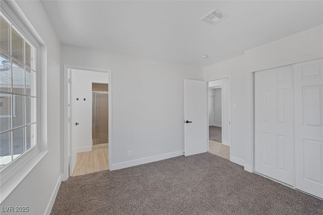 Unfurnished bedroom featuring carpet flooring, multiple windows, a closet, and connected bathroom | Image 25