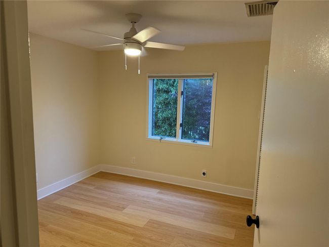 Spare room featuring light wood-type flooring and a ceiling fan | Image 23