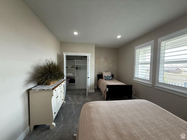 Bedroom with a closet, a walk in closet, dark colored carpet, baseboards, and recessed lighting | Image 66