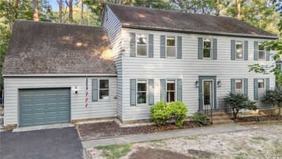 Colonial-style house featuring a garage | Image 1