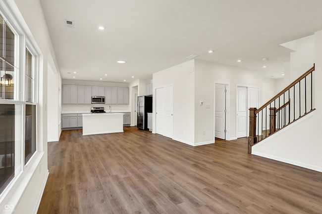 unfurnished living room featuring visible vents, baseboards, stairs, recessed lighting, and wood finished floors | Image 8