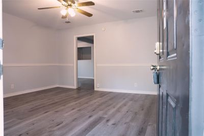 Unfurnished room with dark hardwood / wood-style flooring and ceiling fan | Image 2