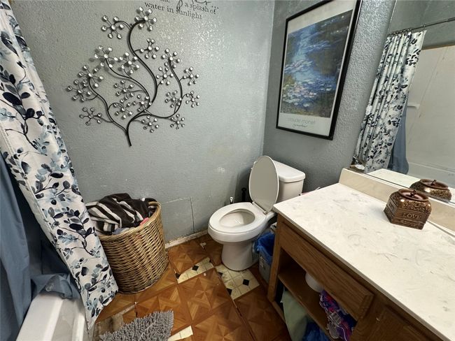 Full bath featuring vanity and shower / bath combination with curtain | Image 12