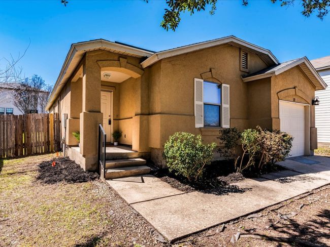 A lovely arching covered front entry welcomes you home. | Image 9