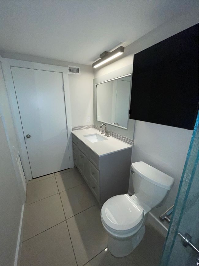 Bathroom featuring toilet, vanity, and tile patterned floors | Image 14