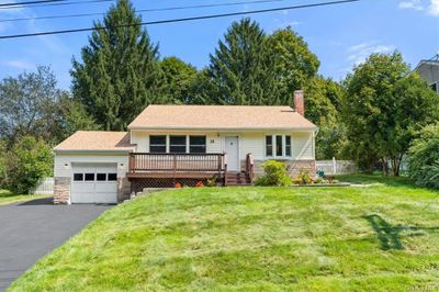 View of front of home with a front yard and a garage | Image 1