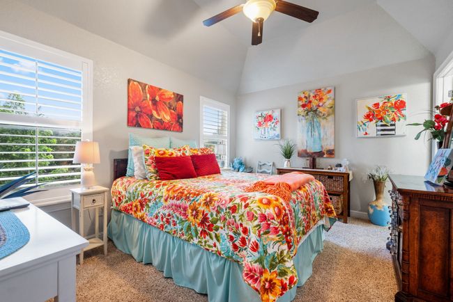 Bedroom featuring light carpet, lofted ceiling, and a ceiling fan | Image 29