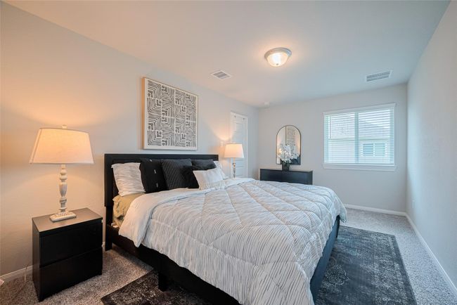 This cozy bedroom has a large window for natural light creating a warm and inviting atmosphere. | Image 45