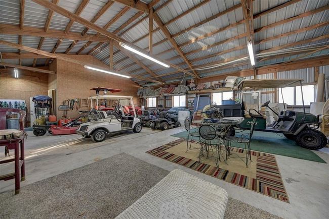 Barn with tack area. Nice and bright. There are three horse stalls through the rear door. | Image 47