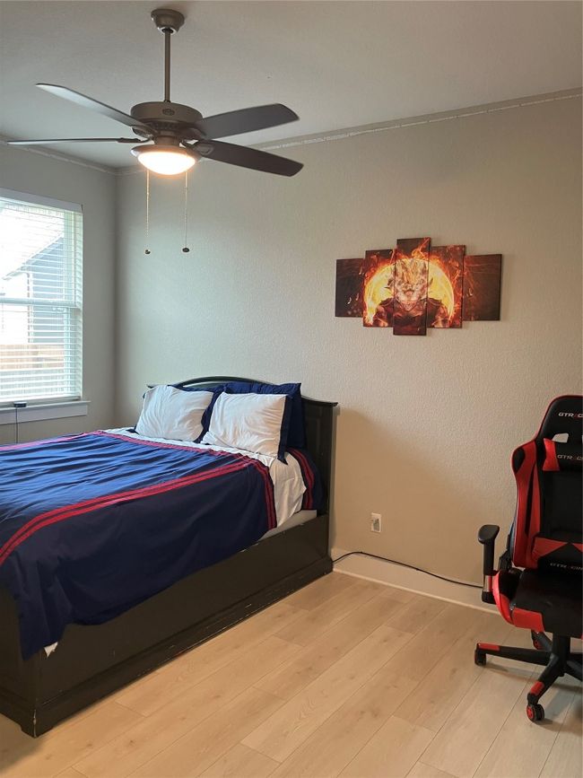 Bedroom featuring wood finished floors, ceiling fan, and baseboards | Image 17