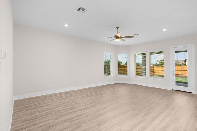 Spare room with ceiling fan, light wood finished floors, baseboards, and recessed lighting | Image 6