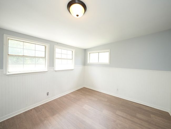 Spare room with wainscoting and wood finished floors | Image 20