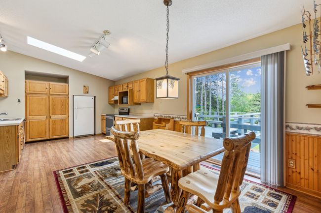 Kitchen/Dining area includes a sliding patio door to the deck and backyard making grilling and entertaining easy. | Image 15