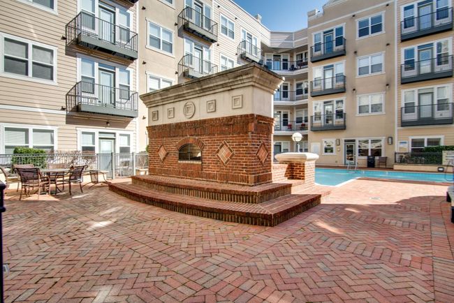 Unwind or entertain in style around the beautifully designed outdoor fireplace—a standout feature of the community’s shared spaces. | Image 19