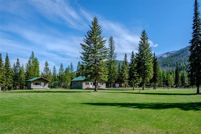 View of property's community featuring a yard, a view of trees, and a mountain view | Image 79