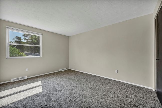 Carpeted spare room with a textured ceiling and baseboards | Image 19