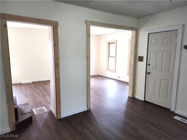 Entryway with dark wood-style floors and baseboards | Image 12