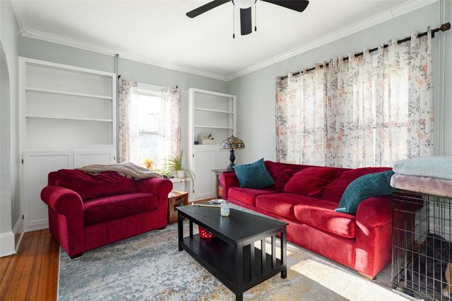 Living room with ceiling fan, hardwood / wood-style floors, and crown molding | Image 5
