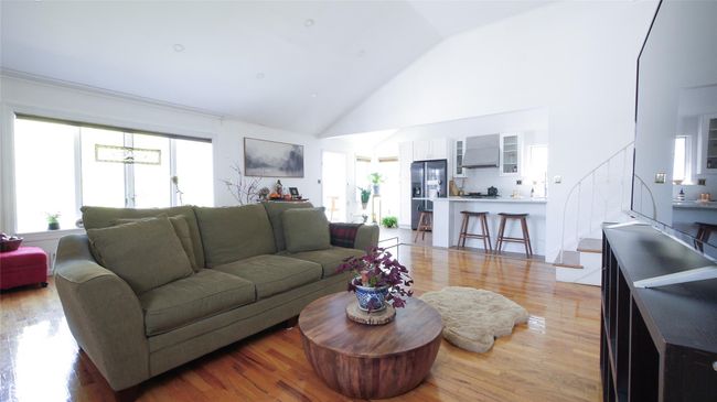 Living room featuring high vaulted ceiling and light wood-style flooring | Image 7
