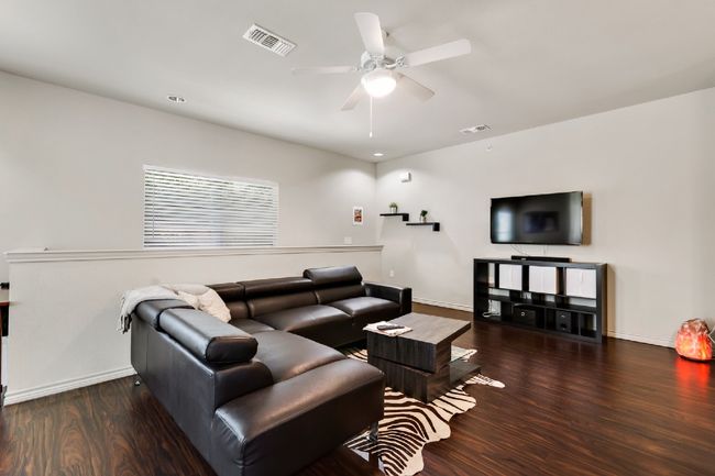 Living room with wood finished floors and a ceiling fan | Image 5
