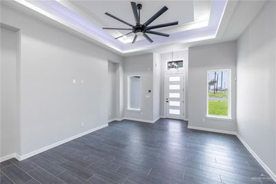 Entryway with a tray ceiling and ceiling fan | Image 2