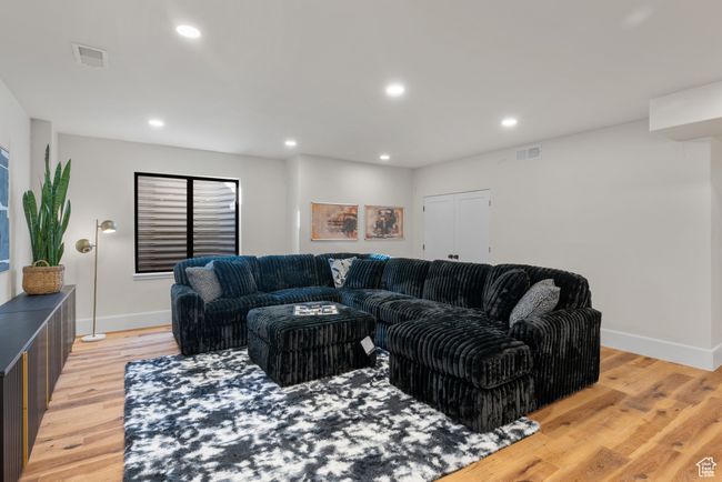 Living room with light wood finished floors and recessed lighting | Image 55