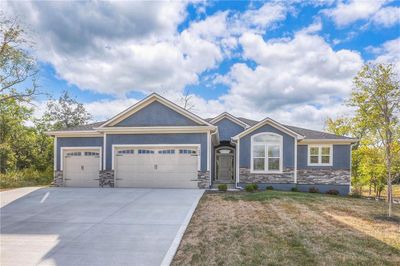 Craftsman-style house featuring a front yard and a garage | Image 2