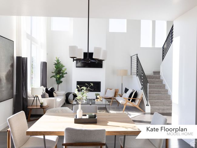 Dining area featuring stairs, a wealth of natural light, and a towering ceiling | Image 5