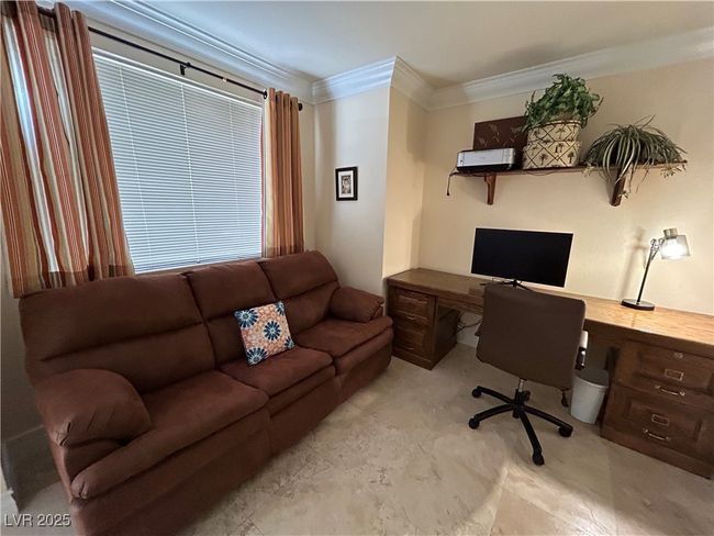 Home office with crown molding, built in study area, and light carpet | Image 31