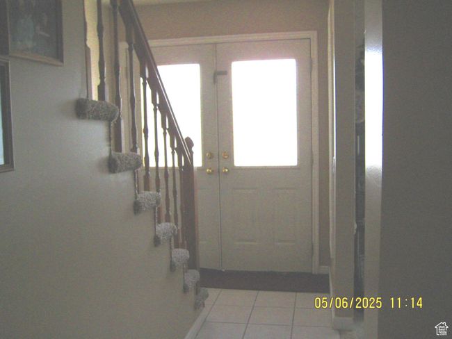 Entryway featuring stairway and tile patterned floors | Image 16
