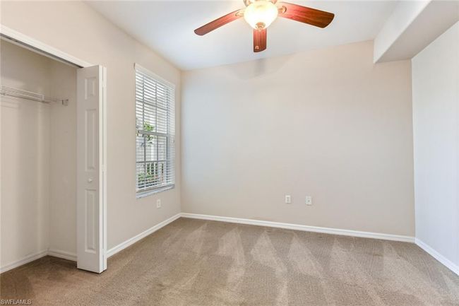 Unfurnished bedroom with a closet, carpet flooring, baseboards, and a ceiling fan | Image 28