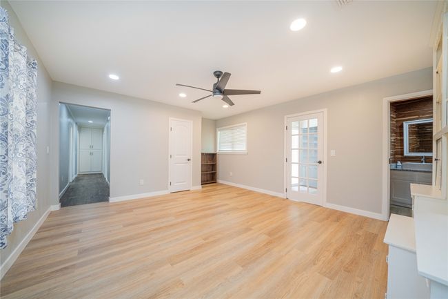 Unfurnished living room featuring a ceiling fan, light wood finished floors, and recessed lighting | Image 20