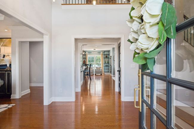 Grand foyer with sightlines to the open living area and rich hardwood floors throughout. | Image 5