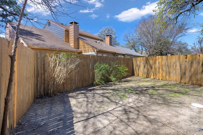 View of patio with a fenced backyard | Image 20