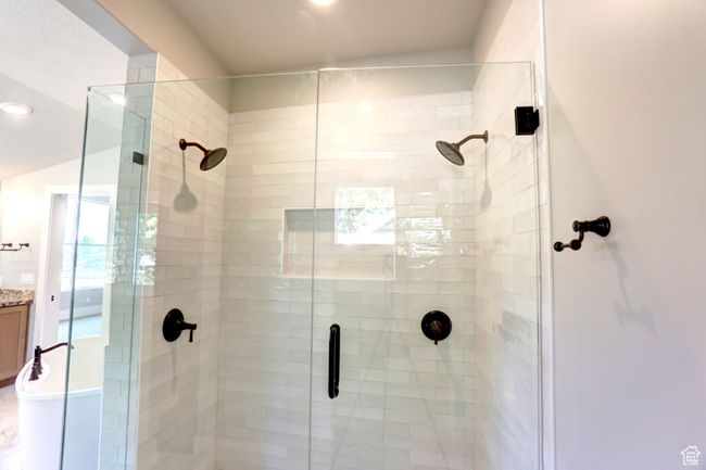 Bathroom featuring a shower stall and vanity | Image 30
