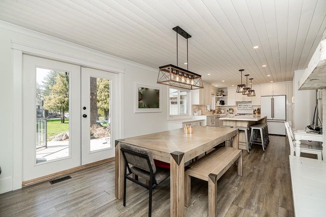 Dining area with visible vents, french doors, a chandelier, recessed lighting, and wood finished floors | Image 4